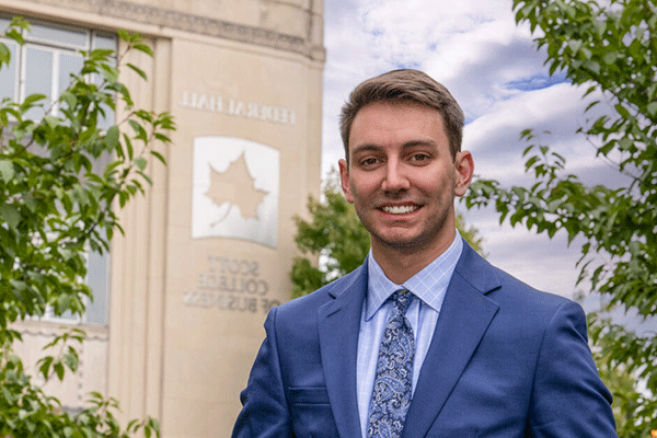 Dylan Mauplin standing in front of the Scott College of Business